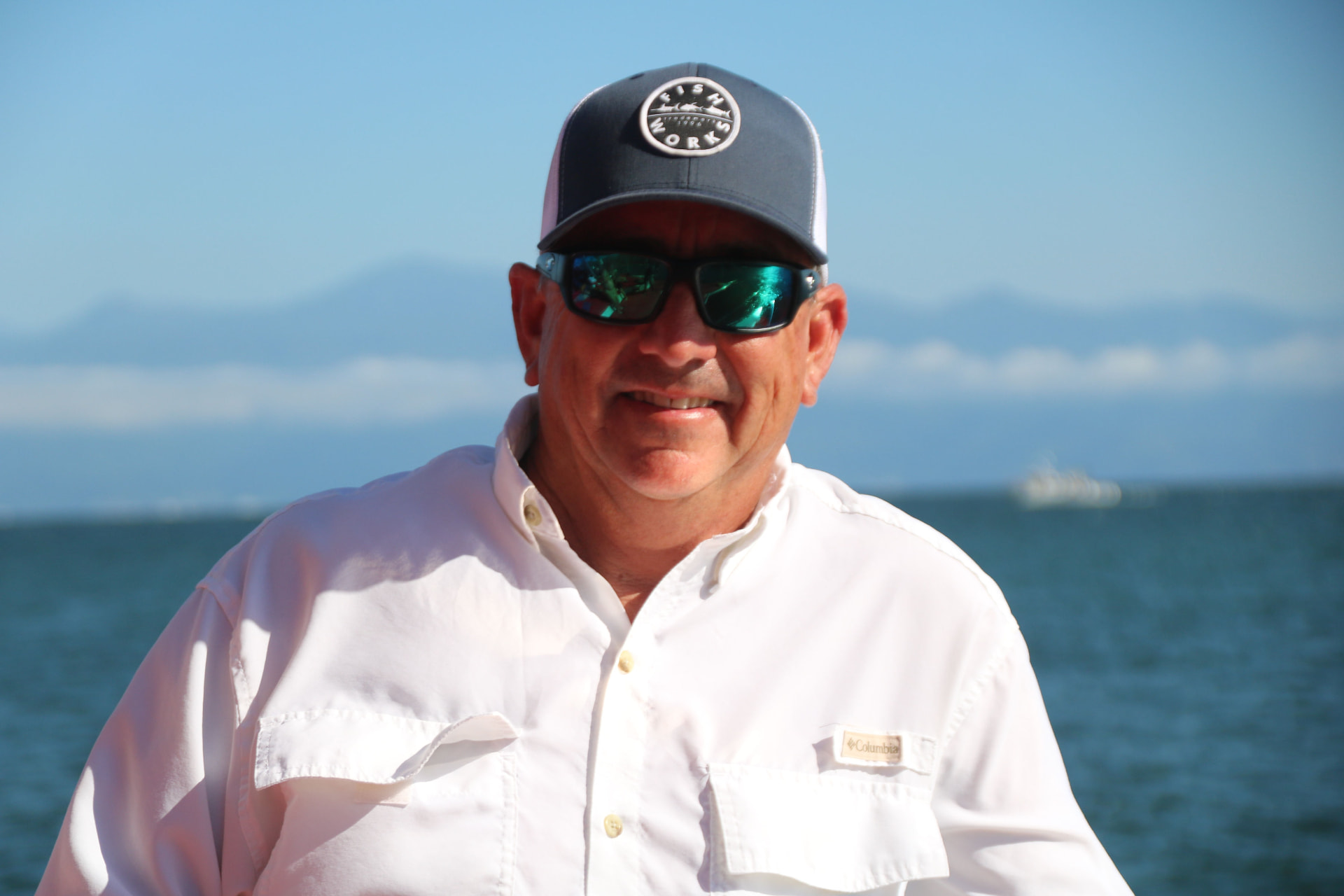 Scott Read, owner of SJR Concrete, outdoors on the water